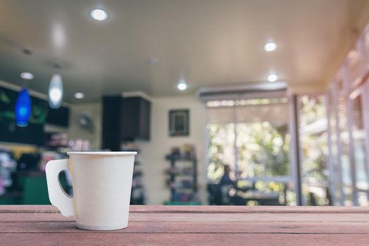 Coffee paper cup in coffee shop blur background