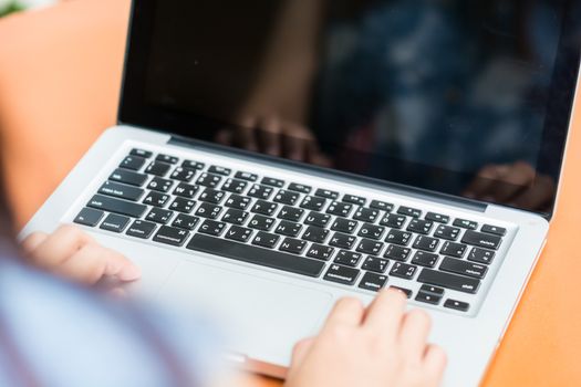 Woman hands typing on laptop outdoors in cafe