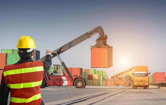 Foreman control forklift uploading truck with fork loader, man in safety uniform