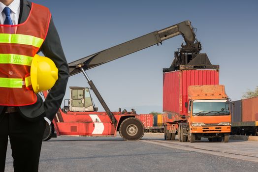 Businessman stand on front forklift loading Containers box to Logistic cargo Import Export