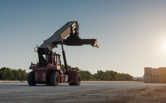 Forklift handling no container box loading at sunset