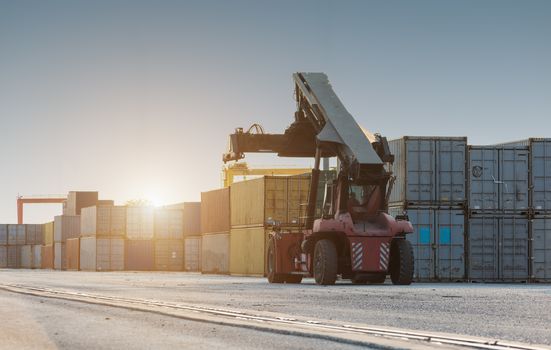 Forklift handling no container box loading at sunset