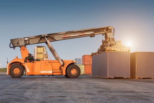 forklift handling holding container box at harbor logistic zone