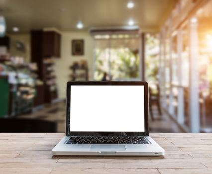 Laptop on wood table in coffee shop