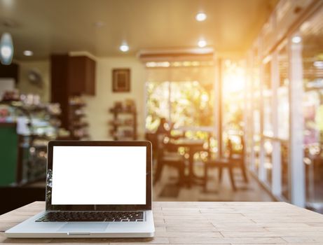 Laptop on wood table in coffee shop