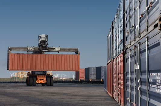 forklift handling container box loading from dock to truck