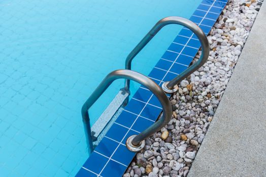 Hotel blue swimming pool with stair for relaxation