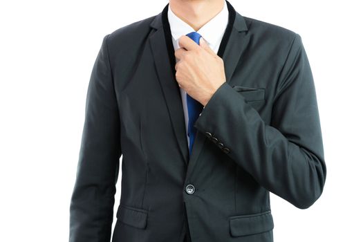 Businessman adjusting necktie isolated on over white background