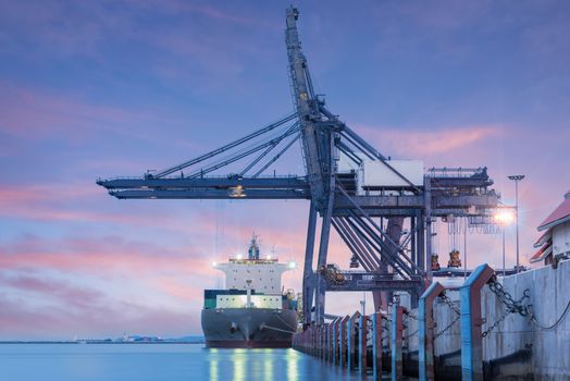 Container Cargo freight ship by crane bridge, logistics harbor at sunrise