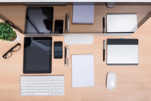 Top view office wite computer PC, tablet, mobile phone, keyboard and mouse on wooden desk