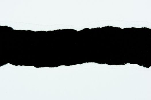 tear white paper pieces of paper on black background