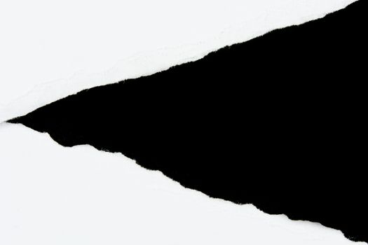 tear white paper pieces of paper on black background