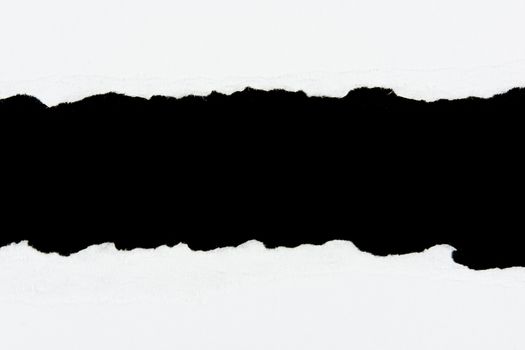 tear white paper pieces of paper on black background