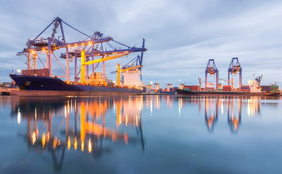 Containers loading Shipping by crane at dark or Trade Port