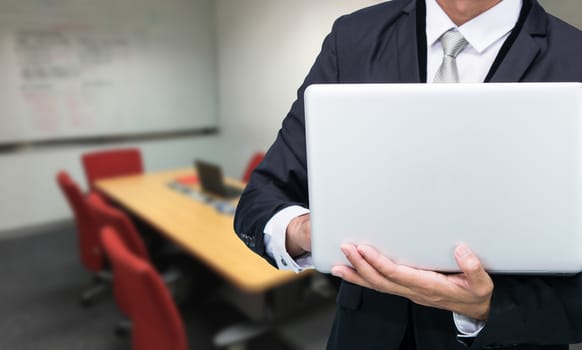 Businessman hold laptop computer in meeting room
