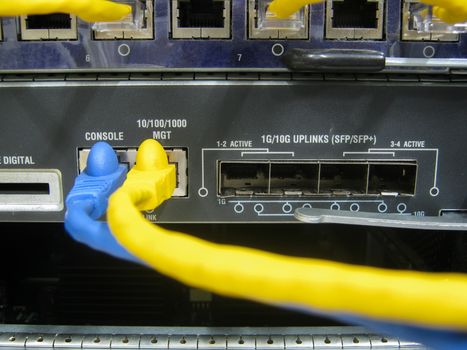 Console cable communications switch equipment installed chassis in large data center.