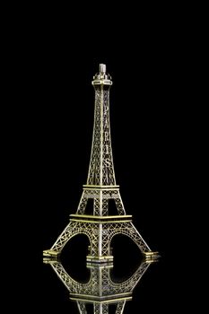 Small Eiffel tower isolated on over black background