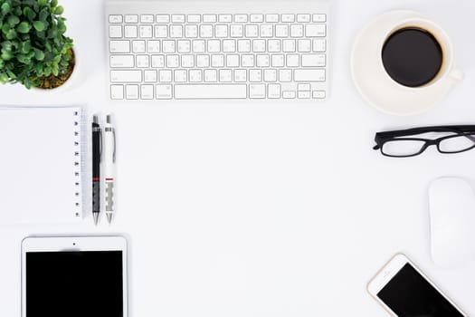 Business desk with a keyboard, mouse and pen on white table