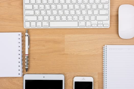 Business desk with a keyboard, mouse and pen on wooden table