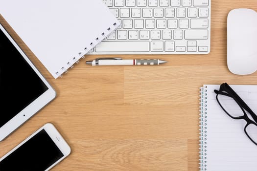 Business desk with a keyboard, mouse and pen on wooden table