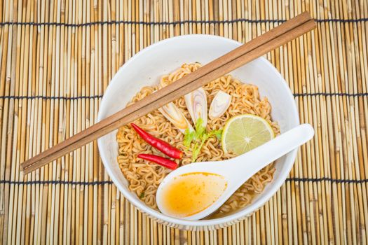Hot and spicy instant noodle on wooden background