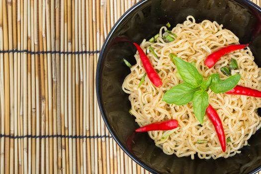 Hot and spicy instant noodle on wooden background