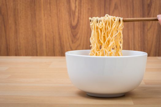 Hot and spicy lap instant noodle on wooden background