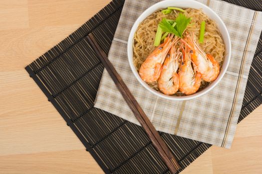 baked vermicelli with shrimp in white cup on wooden background