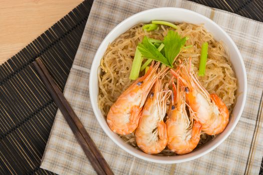 baked vermicelli with shrimp in white cup on wooden background