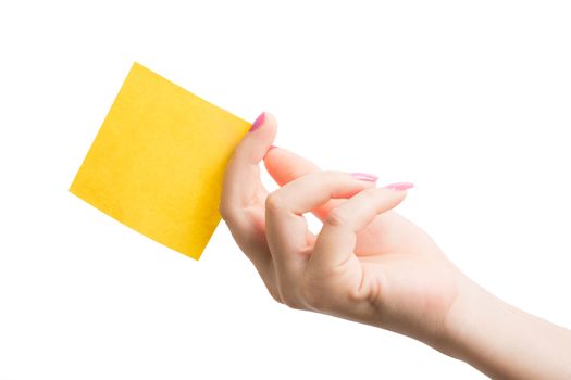 Woman hand holding blank yellow notepaper on over white background