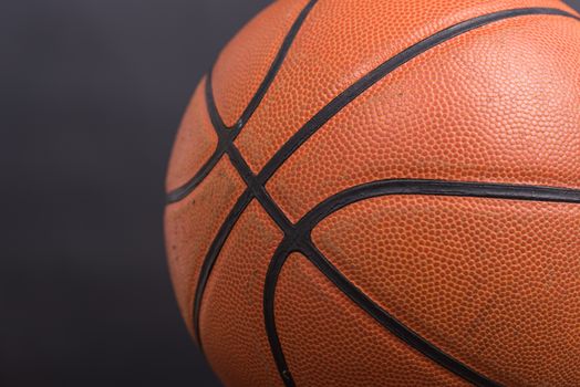 Closeup old basketball basket ball on wooden and black background