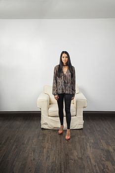 young woman standing in front of a white couch