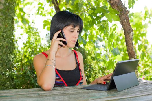 casual woman working with a tablet pc, outdoor