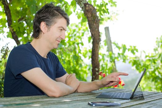 casual man working with a tablet pc, outdoor