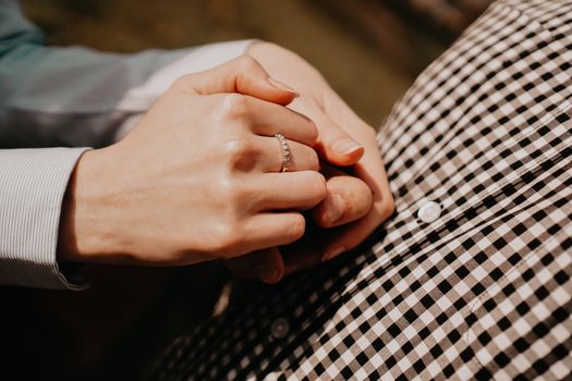 Hands of couple. Couple of lovers holding hands. Hand with ring