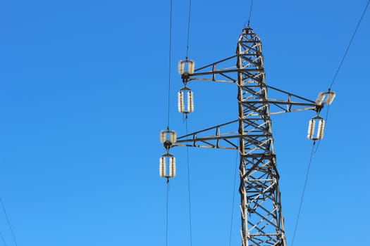 high voltage tower with blue sky in the background