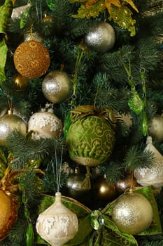 Close up handmade decorations hanging Christmas tree, bows, balls, spheres, front view