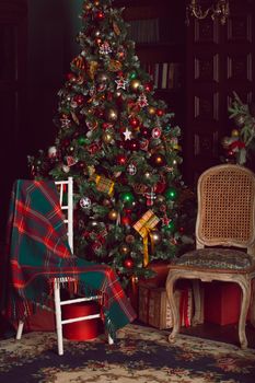 Festive Christmas interior with decorated three and two chairs