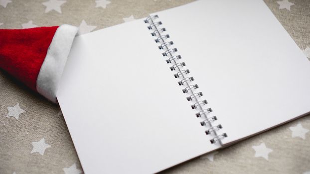 Notebook to write goals of new year on christmas background