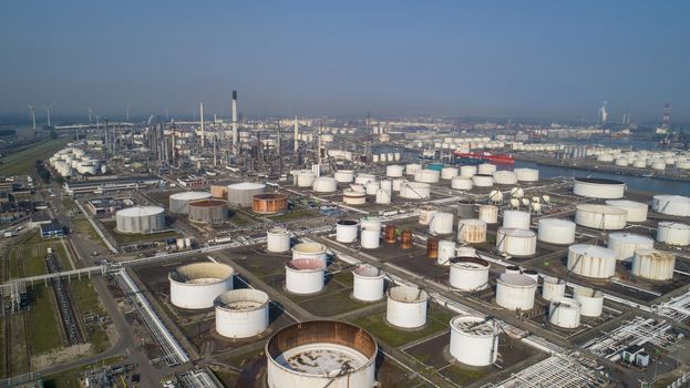 Port of Rotterdam. Botlek. Oil refinery plant from industry zone, Aerial view oil and gas industrial, Refinery factory oil storage tank and pipeline steel