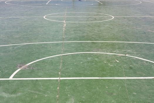 Damaged rundown basketball court on street. Outdoor sport arena. Playground for competition, championship