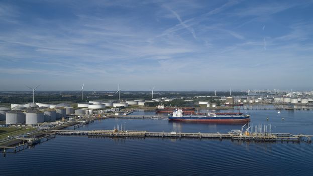 Port of Rotterdam. Botlek. Oil refinery plant from industry zone, Aerial view oil and gas industrial, Refinery factory oil storage tank and pipeline steel