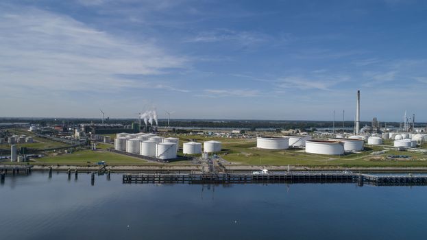 Port of Rotterdam. Botlek. Oil refinery plant from industry zone, Aerial view oil and gas industrial, Refinery factory oil storage tank and pipeline steel