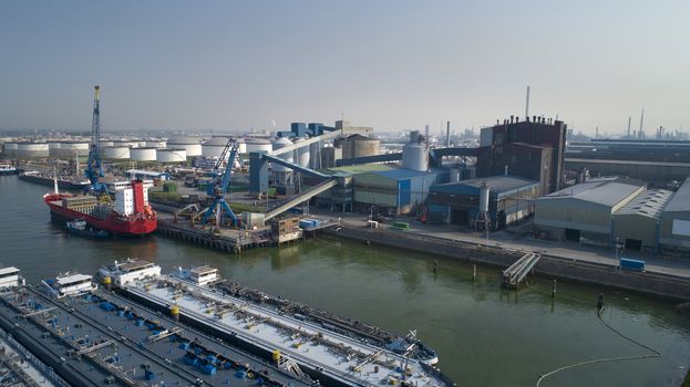 Port of Rotterdam. Botlek. Oil refinery plant from industry zone, Aerial view oil and gas industrial, Refinery factory oil storage tank and pipeline steel