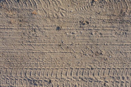 seamless dirt road texture background. Tracks of cars on the sand in the desert sand
