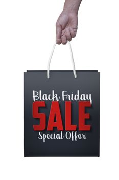 Black Friday paper bag at the white color background with woman hand. Promotional concept.