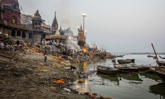 Hindu cremation ceremony at Manikarnika Ghat on banks of holy Ganges river at Varanasi Uttar Pradesh India