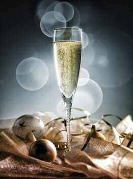 Champagne glass ready to bring in the New Year decoration on golden and silver background
