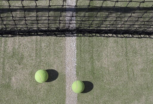 Tennis Balls with Net in the Background