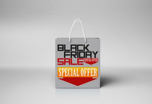 Black Friday paper bag at the white color background with woman hand. Promotional concept